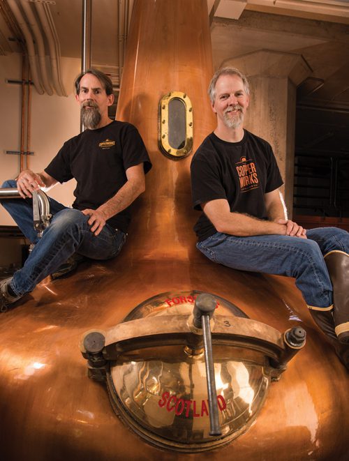 At Copper Works Distillery, old friends Michah Nutt (left) and Jason Parker have embraced the distiller’s lifestyle. LStop-Photo.com