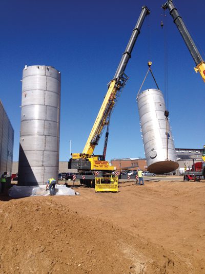 Workers set holding tanks a Bell's new treatment facility, which is scheduled to go online in December.