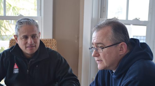 Chaplain Angel Collazo, left, meets with workers as one of the 165 Corporate Chaplains of America. He helps employees deal with life’s joys and sorrows at FONA International in Geneva, Ill., and four other businesses.