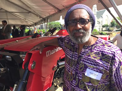Malik Yakini of D-Town Farm in Detroit receives a Mahindra 4025 4WD tractor from Mahindra North American Technology Center and Mahindra USA as part of its Urban Agriculture Grant Program.