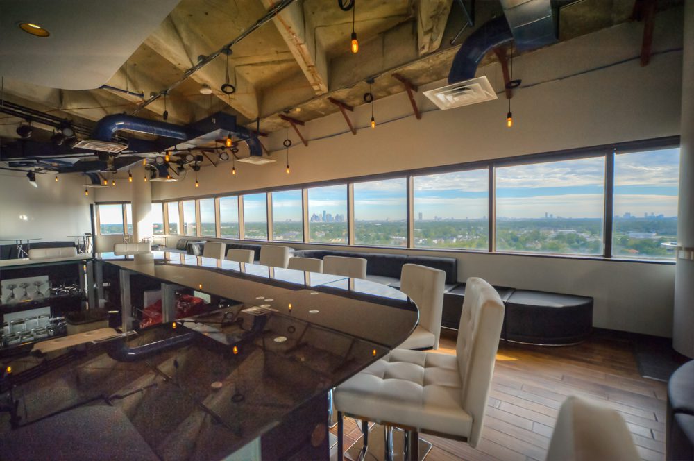 The lounge looks out on a sweeping view of the Houston area and the downtown skyline.