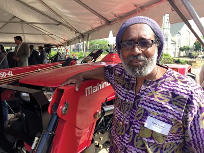 Mahindra USA is making a point to contribute locally. Farmer Malik Yakini accepts a tractor this spring from the company as part of its Urban Ag program in Detroit.
