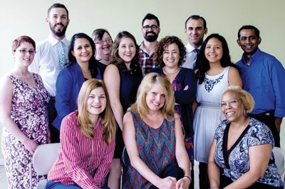The team at Bromberg & Associates in Hamtramck, Mich. Bridging cultural and linguistic divides is core to the translantion services company, founded by CEO Jinny Bromberg, fourth from left in second row.