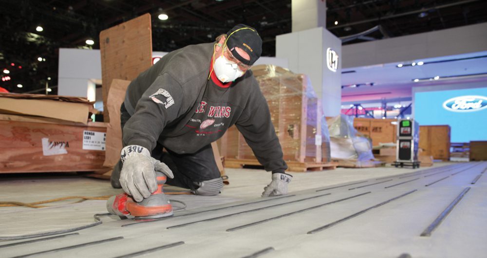 Craftsmen like Aden Springsteen, seen sanding metal at the Honda display, began working on the Detroit show in October.