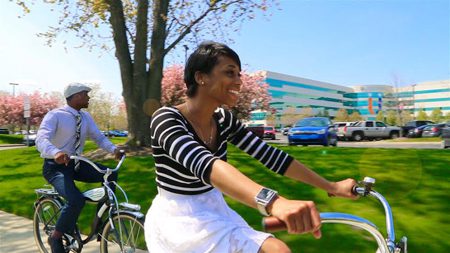 Gabrialle and Bobby Christian enjoying a casual ride around United Shore’s campus on the company’s new “UBike” bicycle sharing program  [note: they are married millennials both working at United Shore]