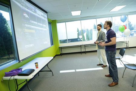 Mark Berry and Alen Serifovic go head-to-head in a game of Madden 2016 in United Shore’s cafeteria.