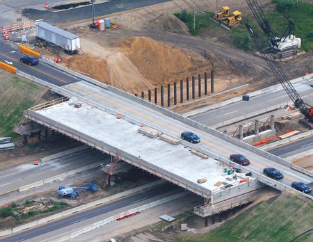 This Alden Nash Avenue bridge as it crosses I-96, shows a “slide in” technique that has the structure assembled next to active lanes. When all is complete, the bridge is (relatively quickly) moved into place.