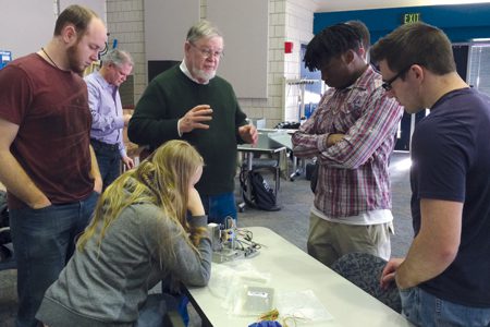 As the culmination of their academic and on the job training, students are given a set of materials, parts and tools to build an electronic device. Students from Henry Ford College work with their instructor at Oakland Community College. Photo by Michigan TED