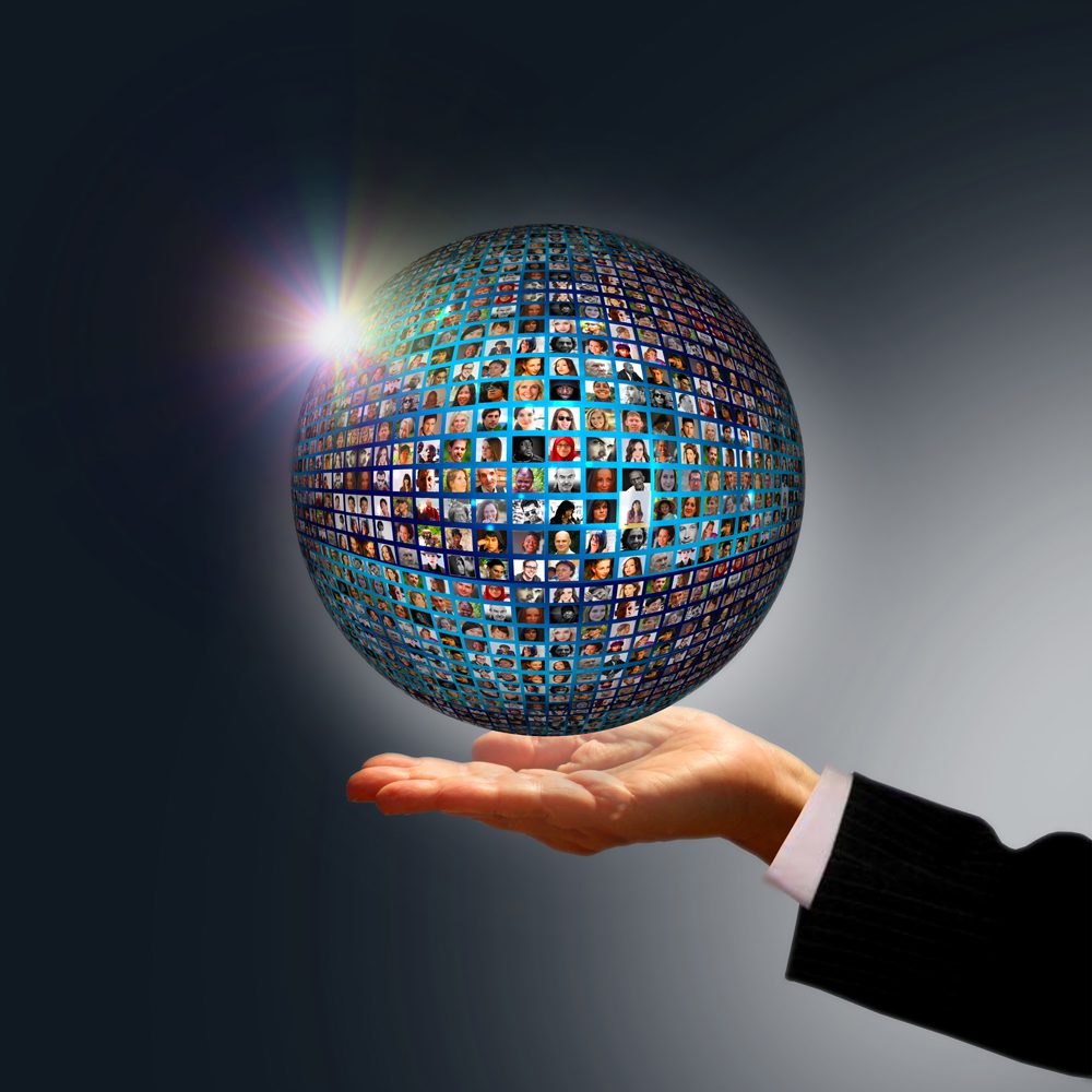 Businessman holding a globe made of people - Social media networ