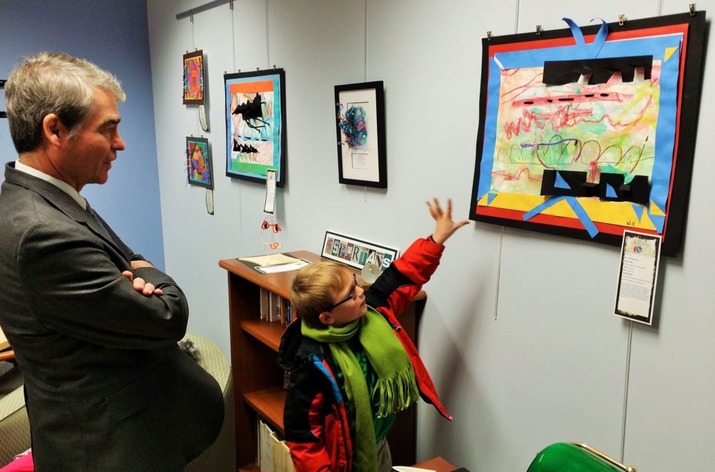 Will Matheson, a first-grader and artist from Walled Lake, stopped by Oakland Schools to visit his masterpiece, hanging on the wall of Assistant Superintendent of Educational Services Dr. Mike Yocum's office.