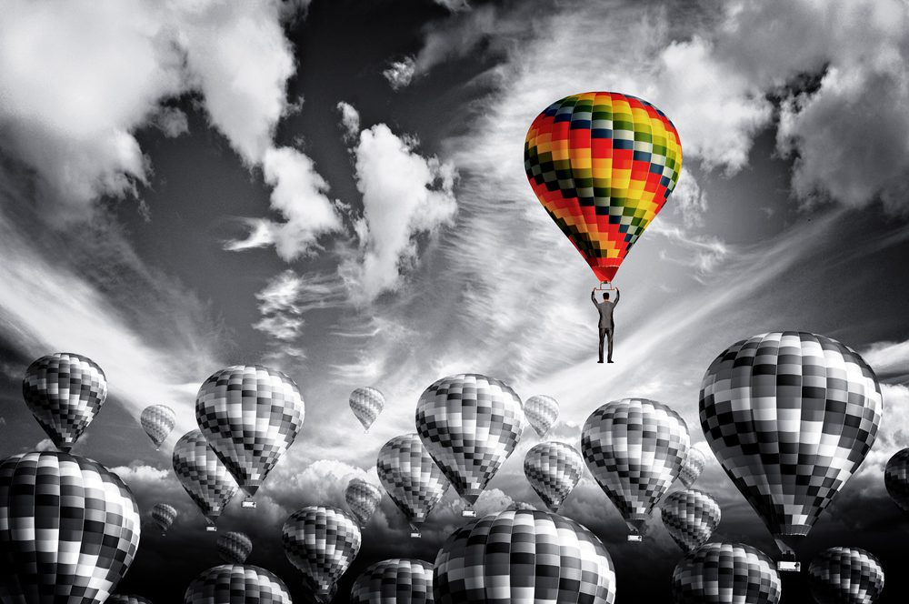 Businessman leader rising in a hot air balloon - Leadership conc