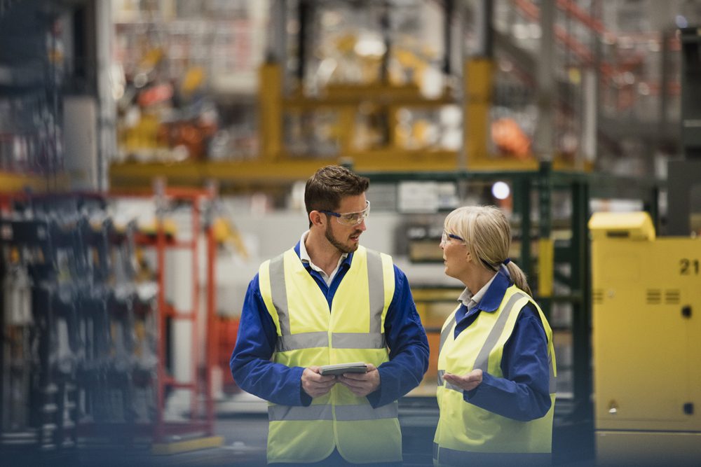 Workers Walking Through a Factory