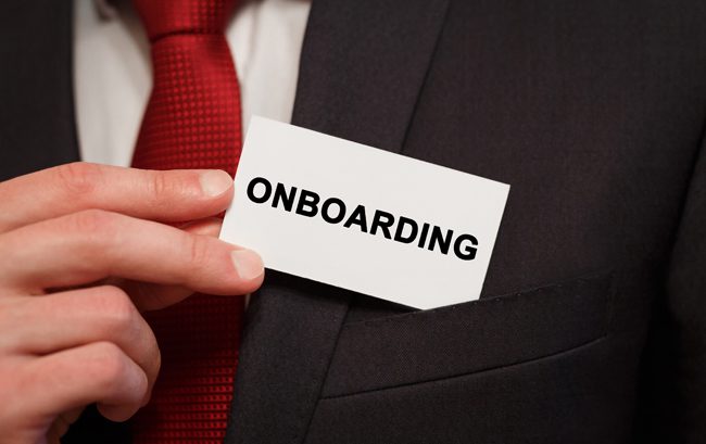 Businessman putting a card with text Onboarding in the pocket