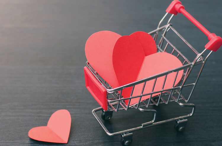 Full of hearts in the shopping cart on wooden floor