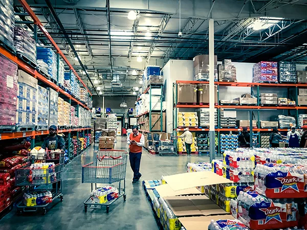 Shoppers stocking bottled water at Costcow Warehouse store