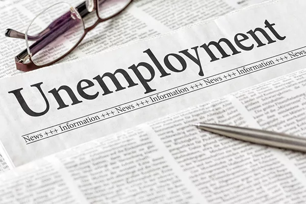 A newspaper with the headline Unemployment
